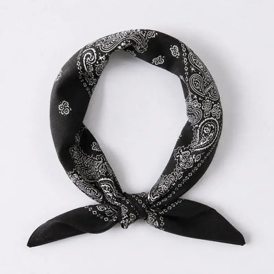 A black bandana scarf with a white paisley pattern, tied in a knot and displayed against a light gray background.