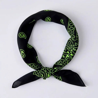 A black bandana scarf with a bright green paisley pattern, tied in a loop to display its design and double tie ends, set against a plain light gray background.