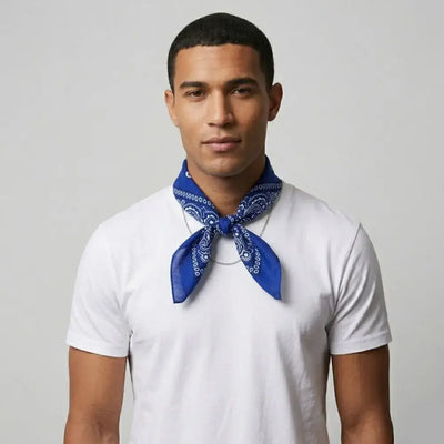 Man wearing a white t-shirt and blue bandana against a gray background