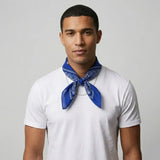Man wearing a white t-shirt and blue bandana against a gray background