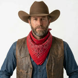 Man wearing a cowboy hat, leather vest, and red bandana on a white background