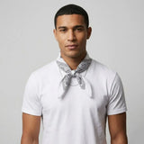 Man wearing a white t-shirt with a white bandana around his neck against a plain background
